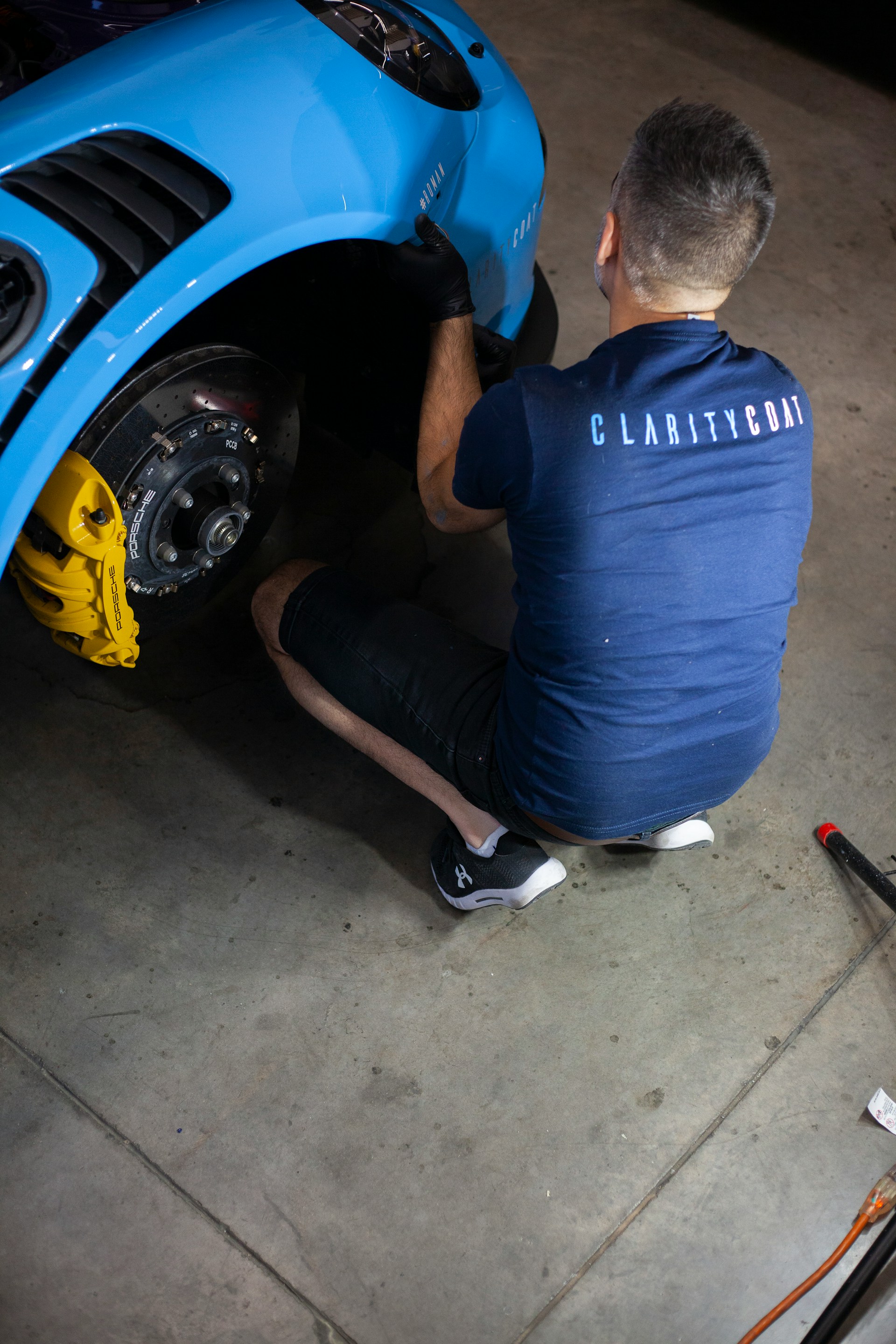 a man working on a car in a garage